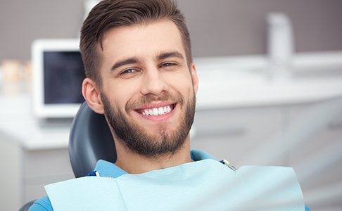 Male patient smiling in treatment chair