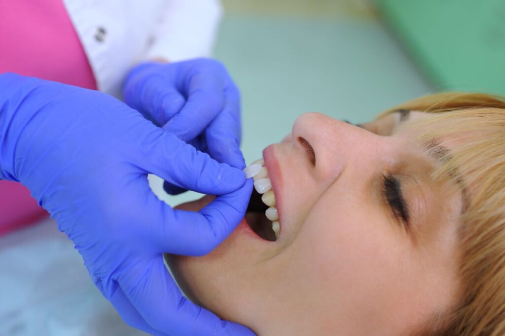 A woman having veneers applied by a dentist.